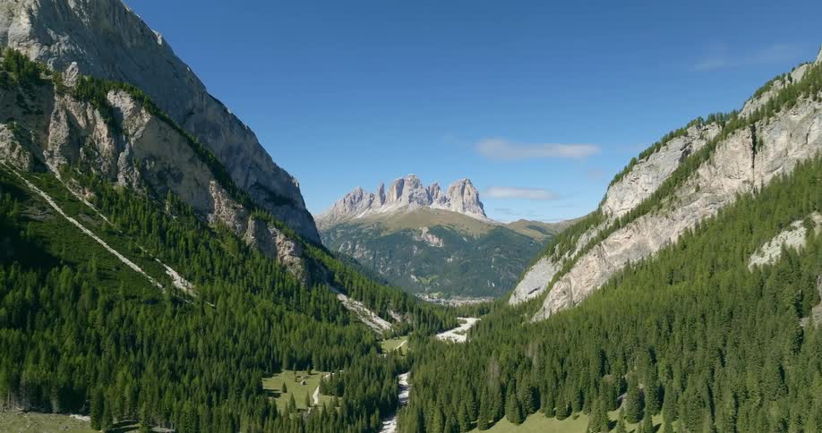 Aerial view of valley with forest and mountains on cloudy day