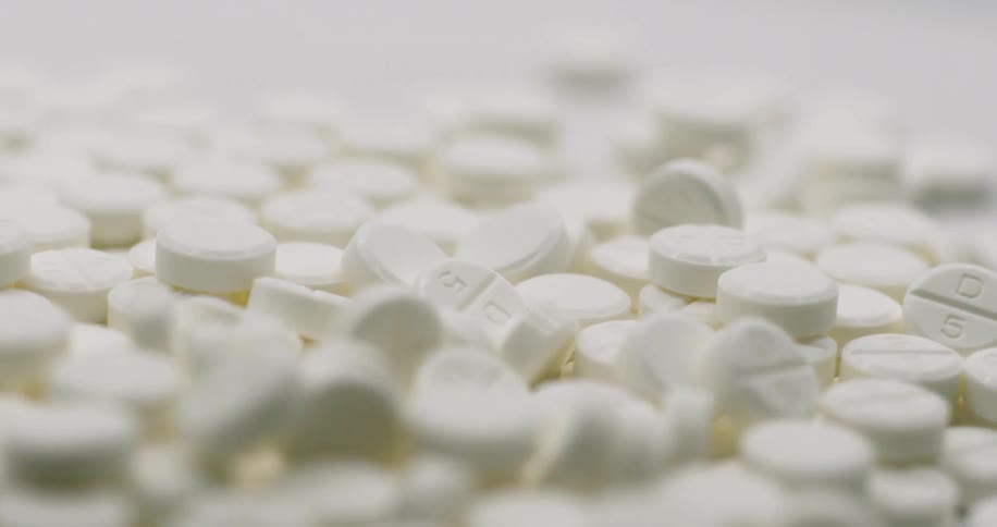 A large pile of pills turning
