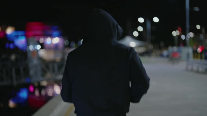 A man is jogging outdoors during the night time