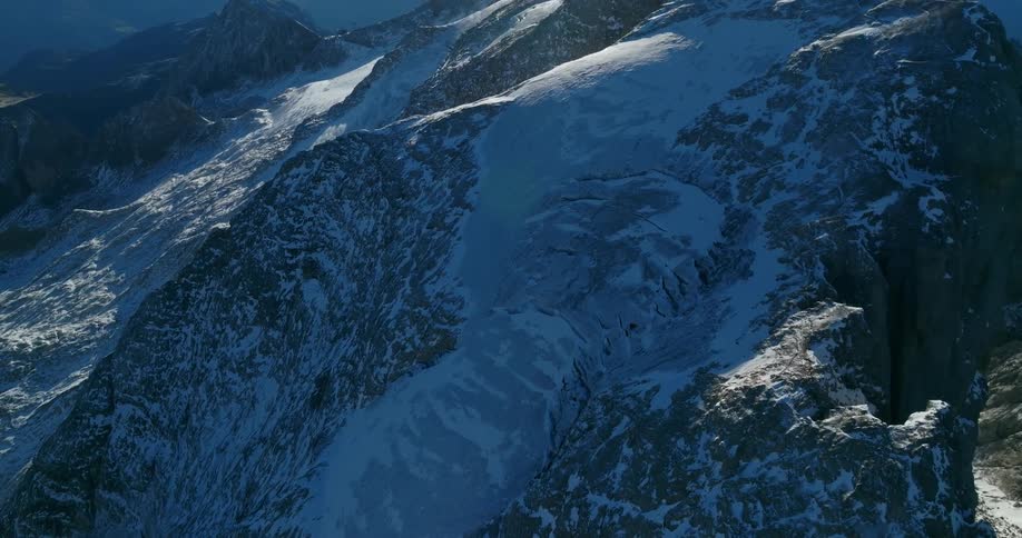 An aerial view of a snow covered mountain range