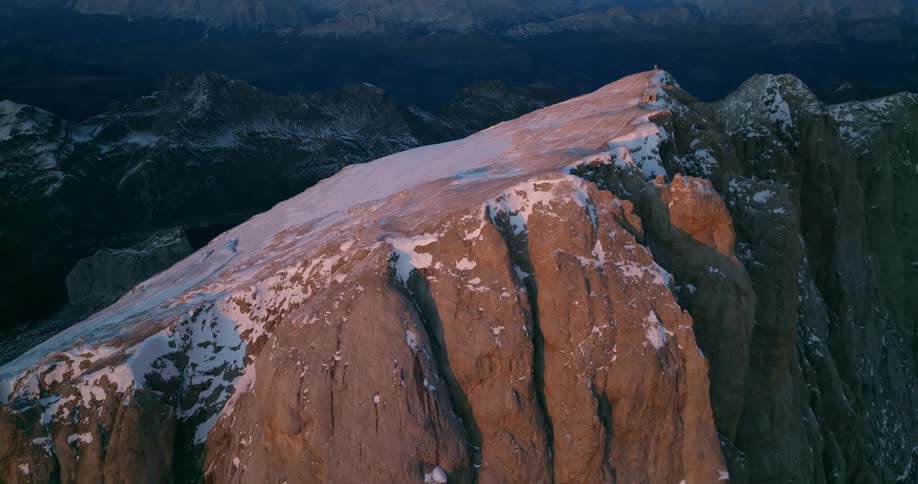 Aerial view of high mountain ridge and snowy slope