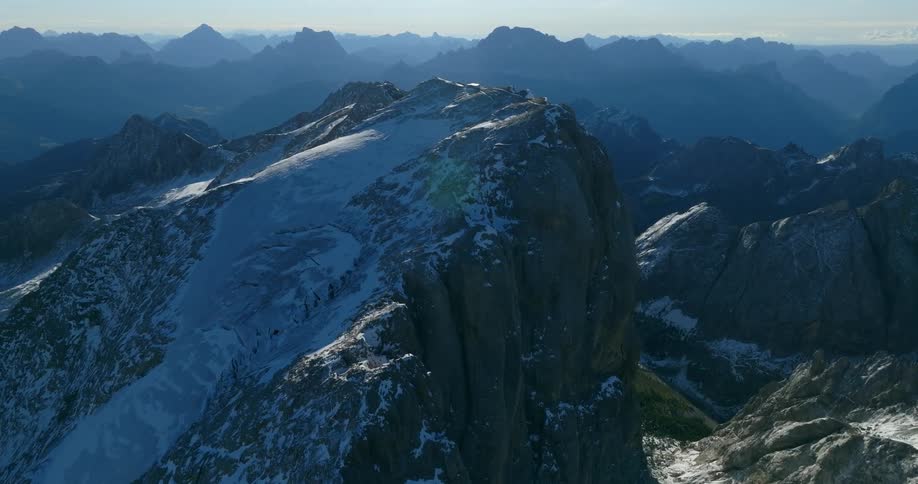 Aerial view of high snowy mountain in mountainous region