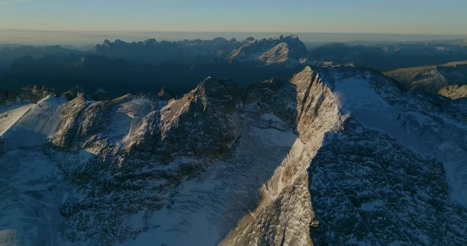 An aerial view of a snow covered mountain range