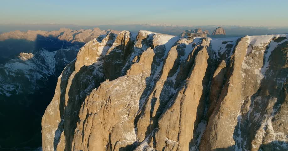 Aerial view of high snowy mountain ridge and building