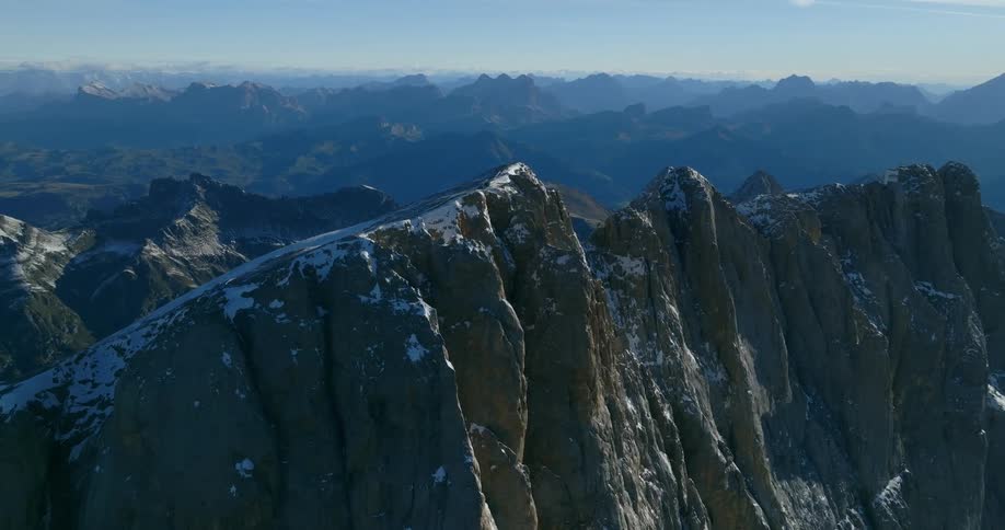 Aerial view of snowy mountain ridge in mountainous region