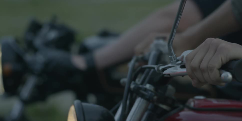People on motorcycles press the handles