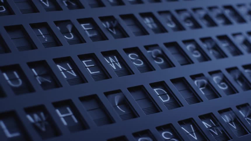 Different parts of old flip display flicker through letters numbers and symbols as central letters spell the word news