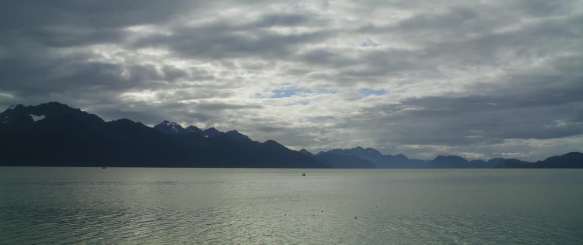 A large lake is near the mountain range