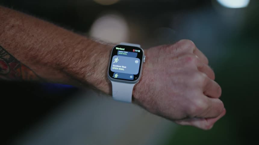 A man activates an app on his smartwatch