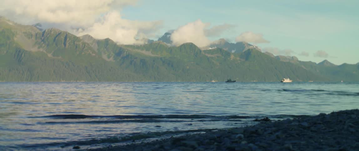 Waves crash on the shore of the river