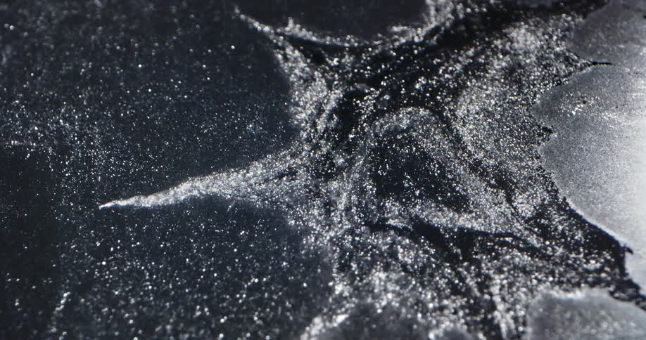 Water spills outward on a flat surface