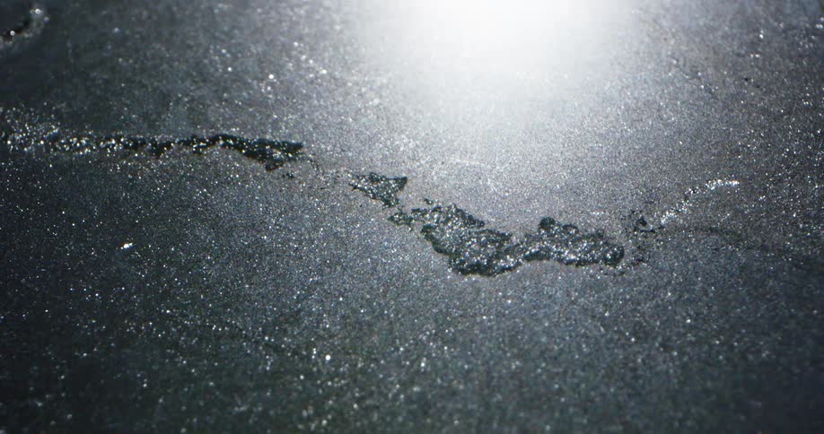 Spilled water flows like a river on a flat surface