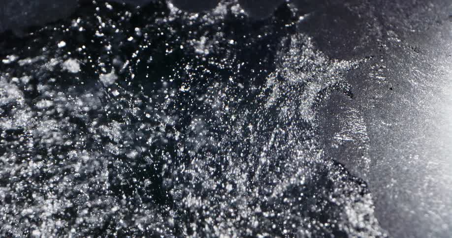 Water flow widens crack in reflective ice sheet