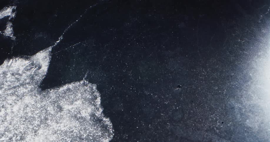 Ice breaking away from flowing water in the sea