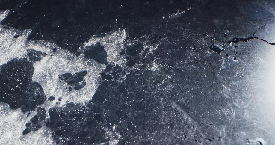 Sparkling flowing water pulls ice sheet apart widening cracks