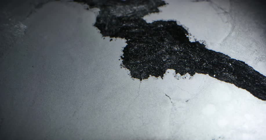 Crack forms in ice sheet and water flows through widening gap