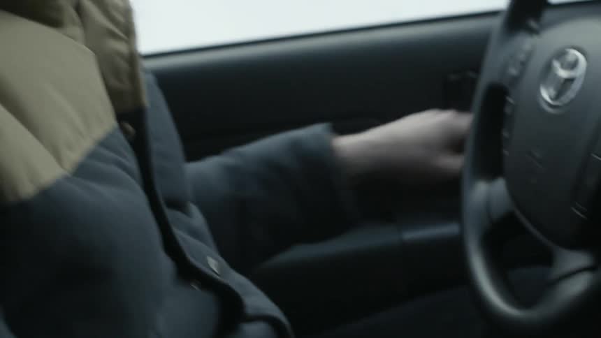 A person parks his car and gets out