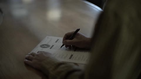 A person filling out a form