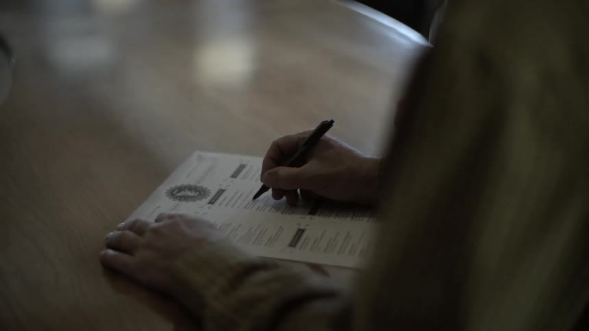 A person filling out a form