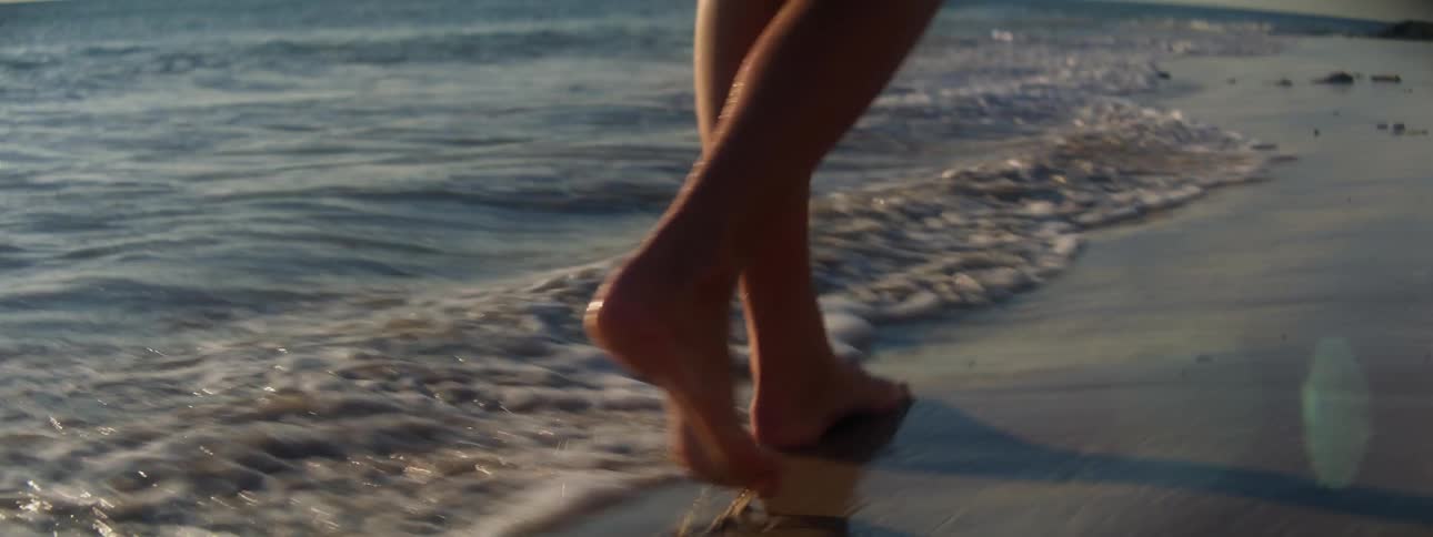 A woman walking outdoors at the beach