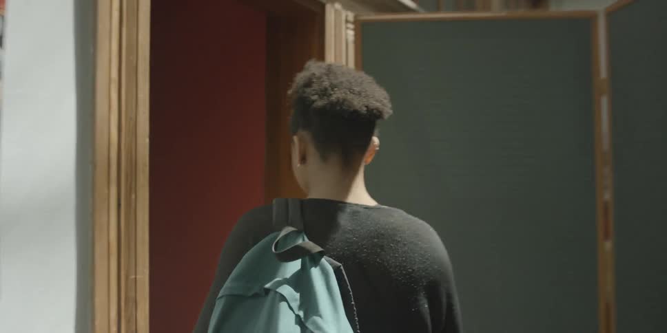 A woman walks down a hall