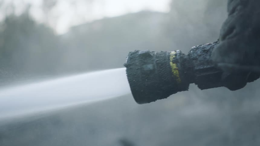 A fireman sprays water during a fire