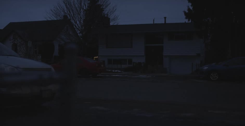 Exterior view of building with lights turning on and off at dawn