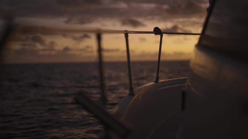 A boat is on the ocean in the middle of the day time