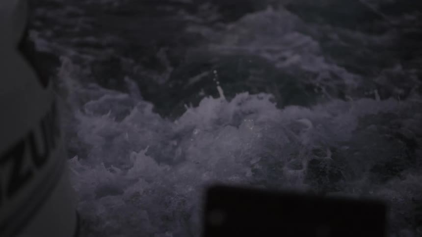 Running boat outboard motor produces bubble on water