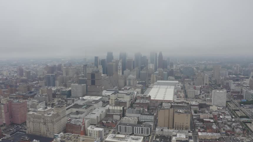 Aerial view of city skyline in fog and buildings