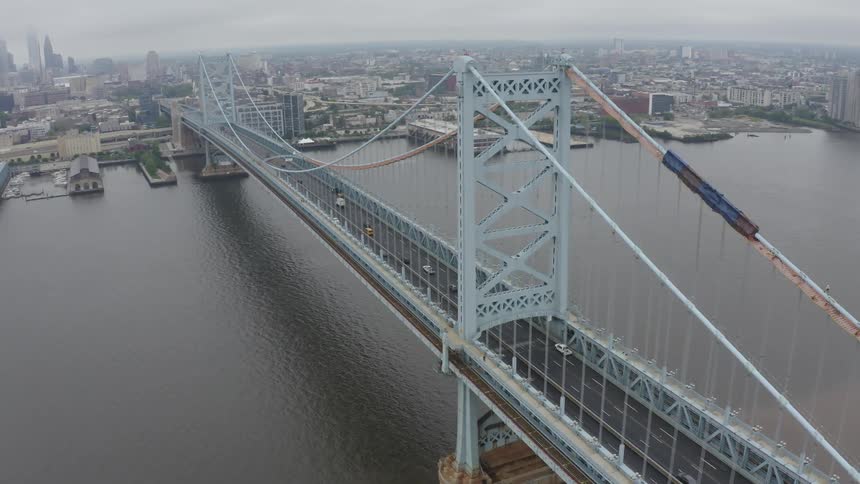 Vehicles driving across a bridge in to the city