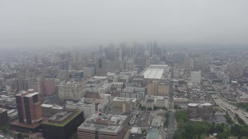 Aerial view of city skyline and buildings under clouds