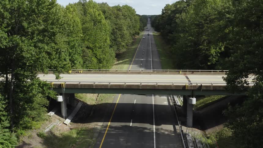 Cars travel on the highway under the overpass