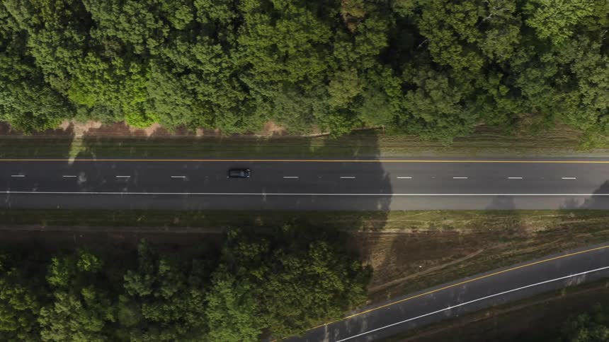 Cars are driving on a road during the spring