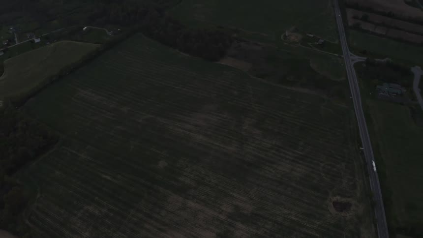 A road runs through the farm land