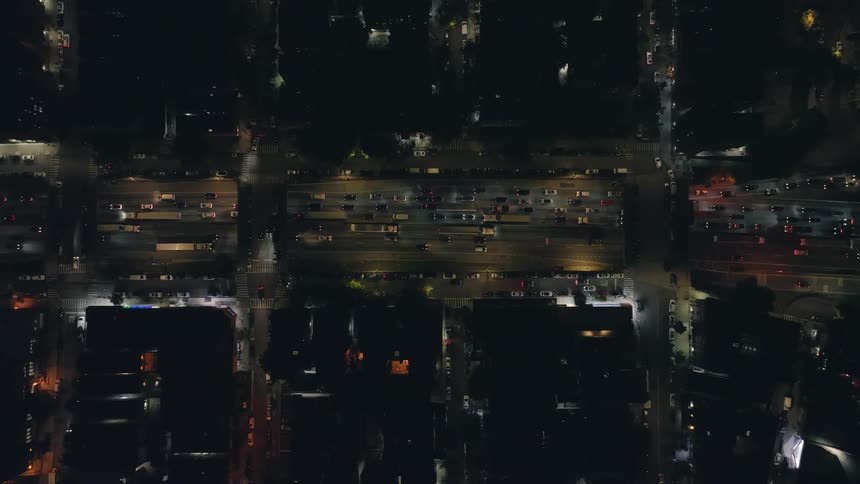 An aerial view of city traffic at night moving slowly and congested