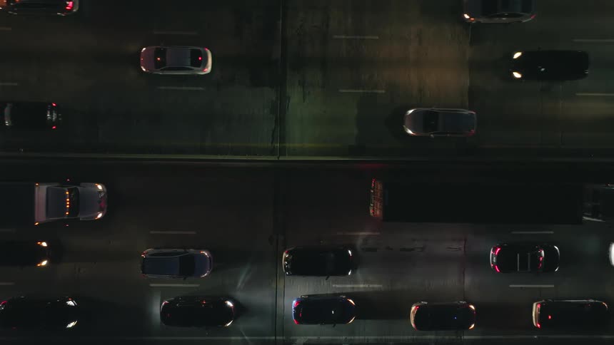 Heavy traffic drives along highway at night