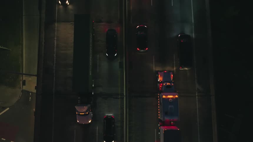 Traffic travels along an overpass at night