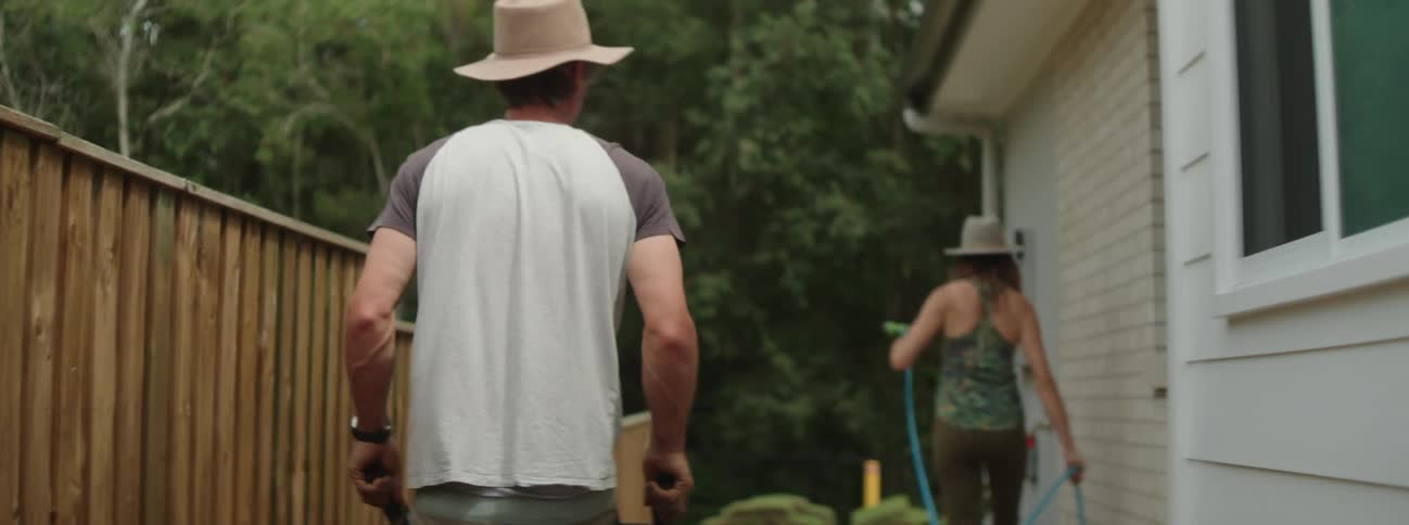 Man and woman are walking in their back yard together