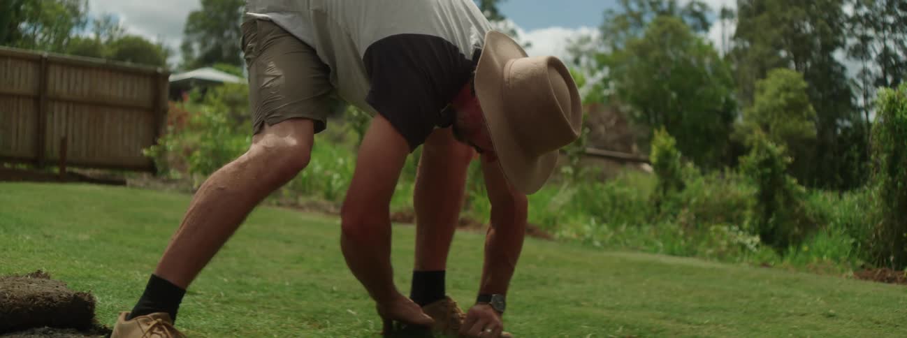 A man is outdoors and gardening during spring