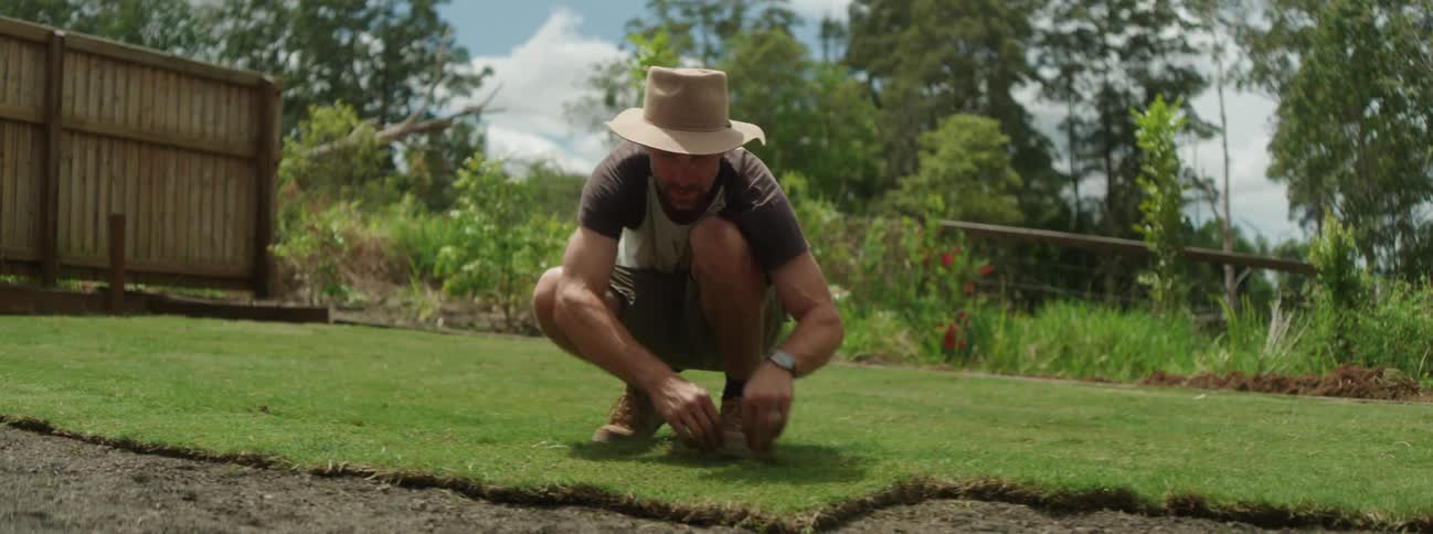 A man is gardening outdoors during the spring