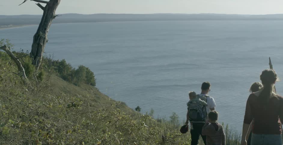 A family hikes towards the coast line