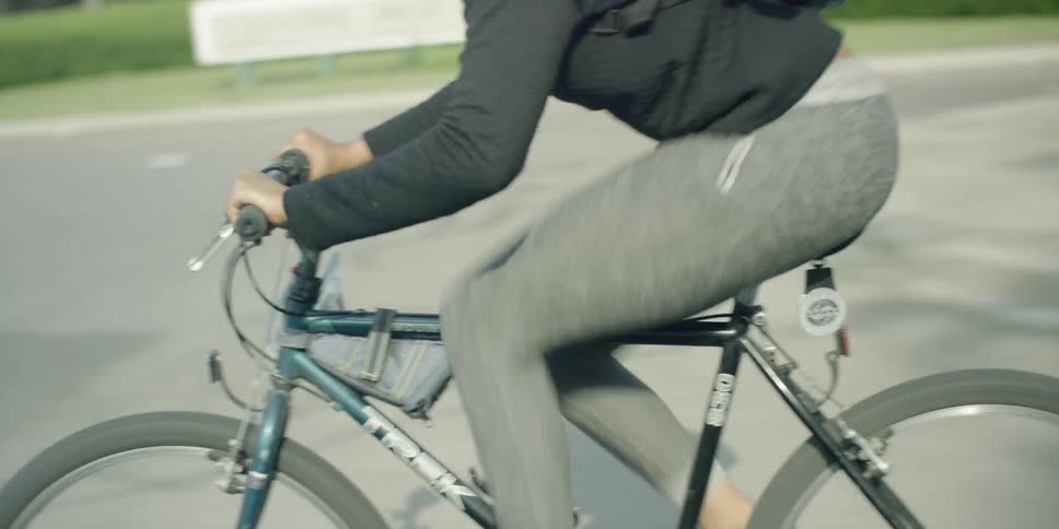 A woman pedaling a bike quickly