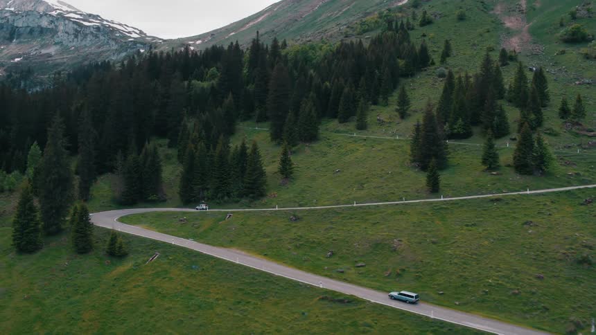 Cars driving on a scenic road in the mountains