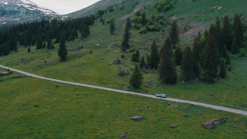 Aerial view of car driving on country road in the countryside
