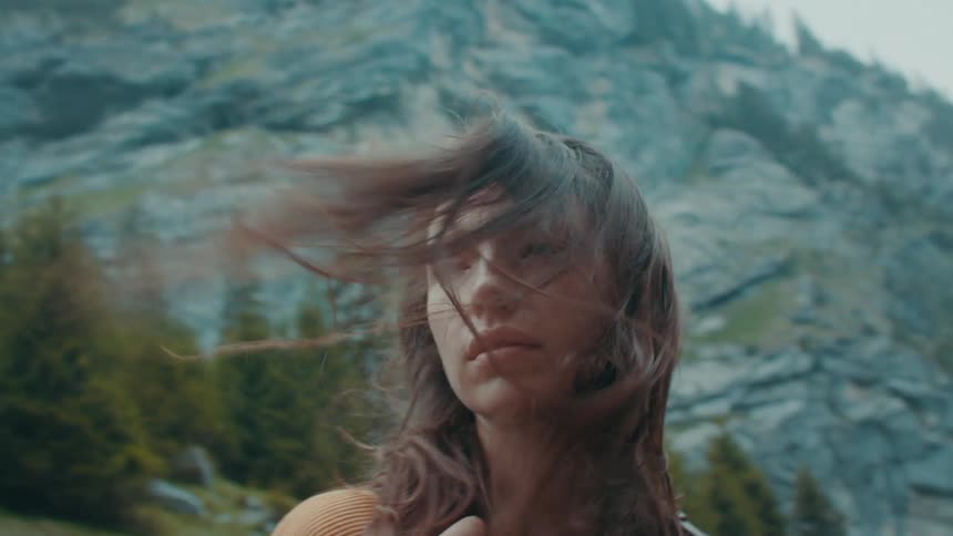 A woman is hiking by the mountain