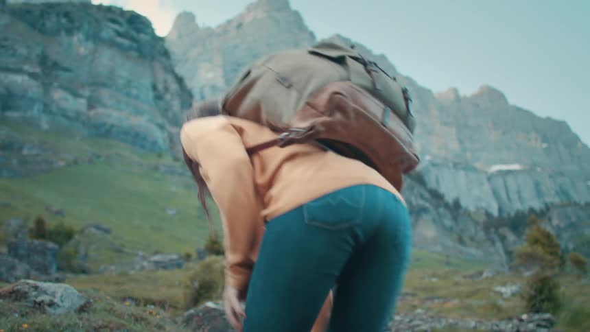 A female hiking up a rocky mountain