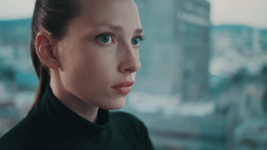 A female wearing black looks nervous and walks away