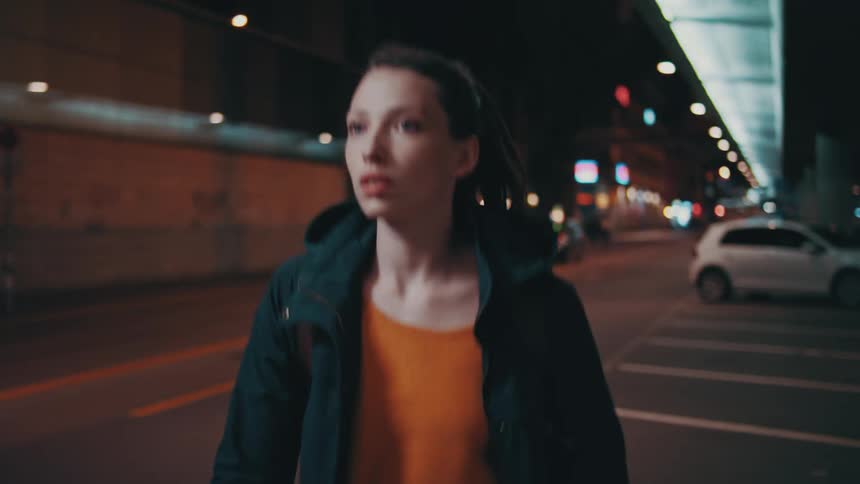 A female walking quickly in a parking lot