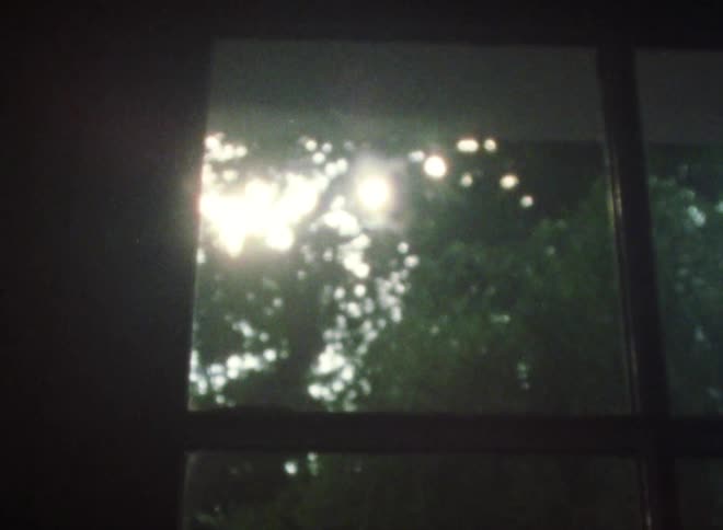 The sun is shining brightly through the trees and in through the window
